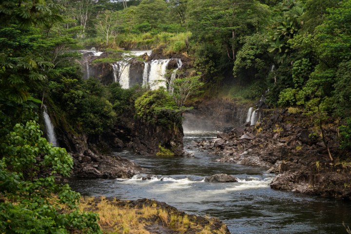 a waterfall going over a body of water